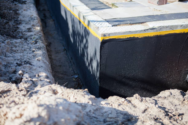 Professional Waterproofing technician working in Winfield, KS